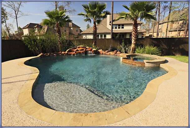 beautiful pool with baja shelf, spa and rock cascade water feature