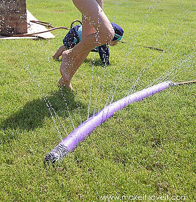 Pool Noodle Sprinkler connected to garden hose, by Make It and Love It