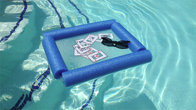 Floating In-Pool Table, from Lifehacker, made from a cutting board and a pool noodle.