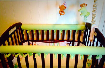 Pool Noodle Baby Crib Rail Bumpers, covered in cloth, by babyneedlist.com