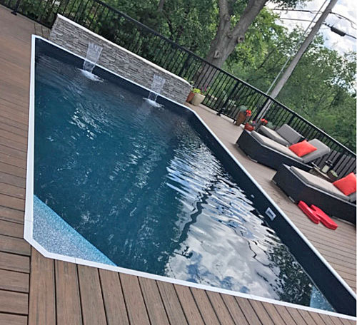 pool with wood deck and water feature