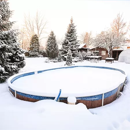 under 2 feet of snow on a pool cover
