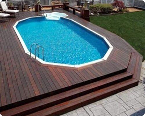 awesome above ground pool sunk into a wooden deck