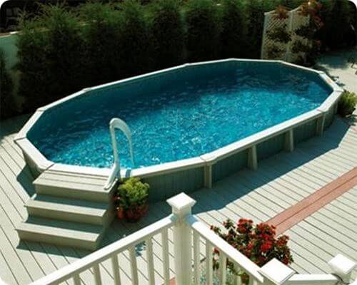 half submerged above ground pool surrounded by a composite pool deck