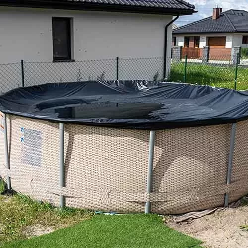 above ground pool with water on top of cover