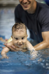 baby taking water safety swim lessons